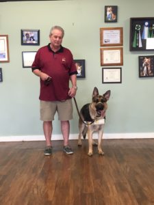 A frontal view of Ike wearing a loose-fitting weighted vest during a CPT behavior modification lesson.